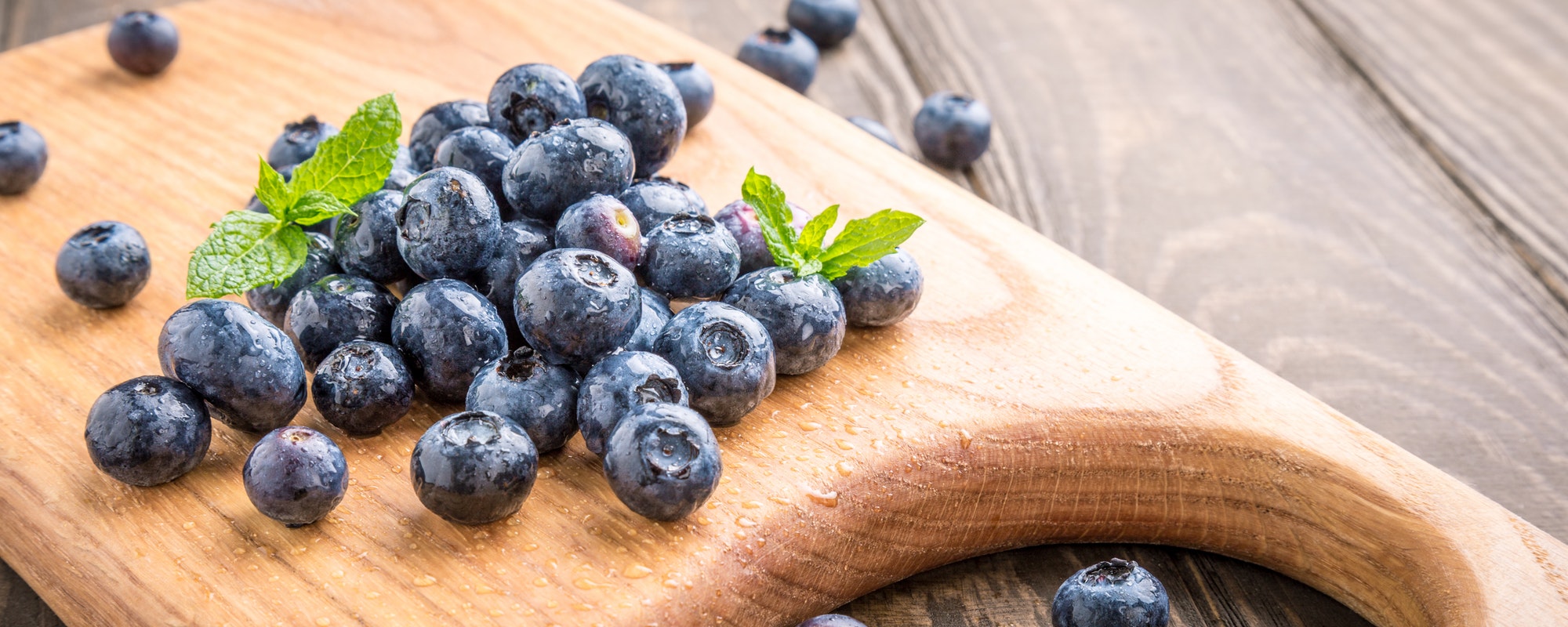 Freshly picked blueberries on wooden board