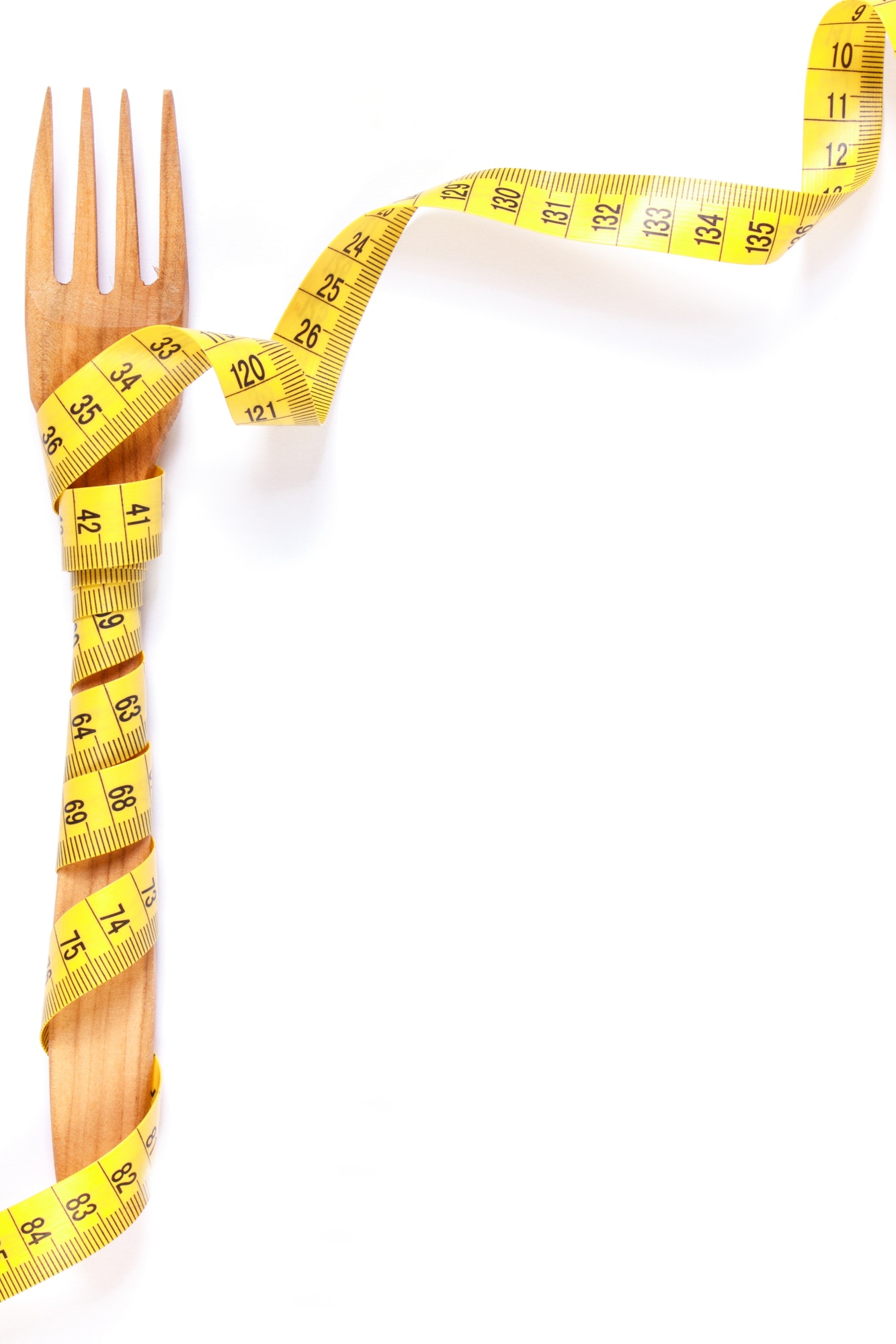 Wooden fork wrapped in centimeter, concept of lose weight and healthy lifestyle